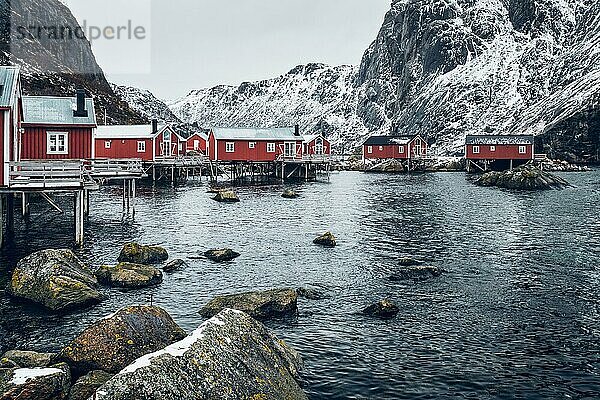 Nusfjord authentic traditional fishing village with traditional red rorbu houses in winter in Norwegian fjord. Lofoten islands  Norway