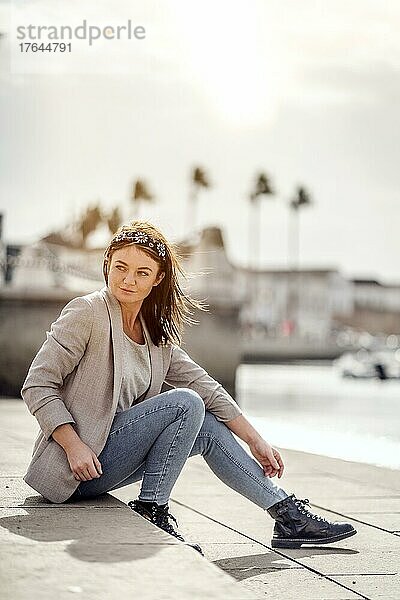 A portrait of a young woman enjoying time outdoor in marina