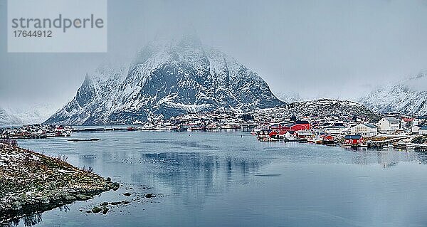 Panorama of Reine fishing village on Lofoten islands with red rorbu houses in winter with snow. Lofoten islands  Norway