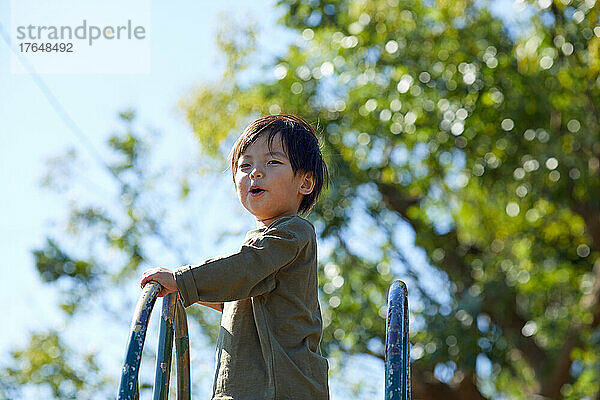 Japanese kid playing at the park