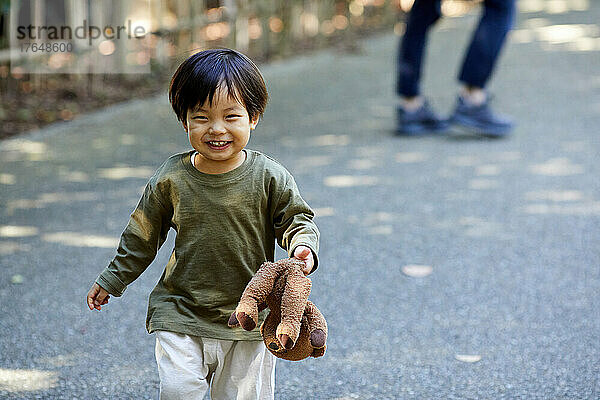 Japanisches Kind spielt im Park