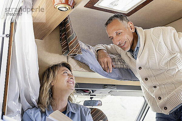 Mature couple talking in motor home on weekend