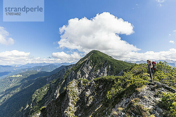 Female hiker taking break to admire summer landscape of Karwendel range
