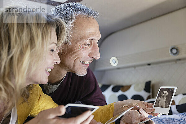 Lächelndes älteres Paar  das sich ein Foto im Wohnmobil ansieht