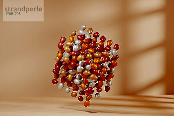 Dreidimensionale Darstellung eines schwebenden Würfels aus metallischen Eiern