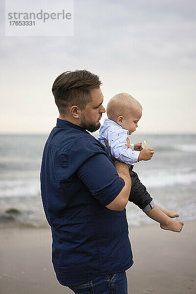 Father with son standing at beach