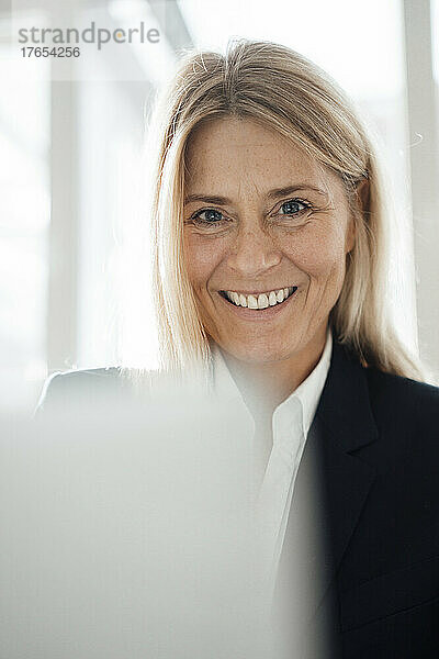 Smiling businesswoman at work place