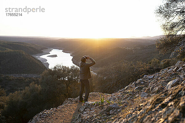 Spain  Province of Caceres  Man bird-watching in Monfrague National Park at sunset