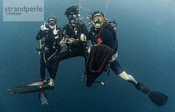 divers at safety stop while on a dive in the Maldives