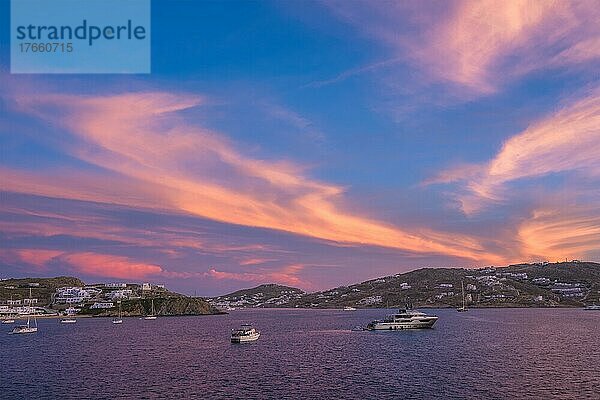 Sunset in Mykonos island  Greece with yachts in the harbor romantic spot on sunset. Mykonos town  Greece
