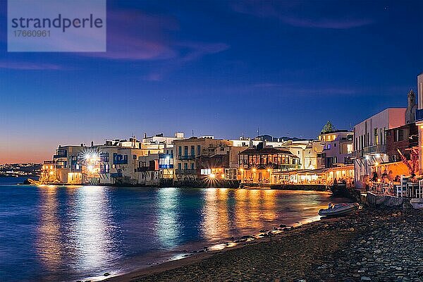 Harbor and colorful waterfront houses of Little Venice romantic spot illuminated in night. Mykonos townd  Greece