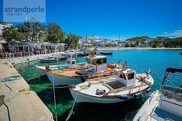 Fishing boats in harbour fishing village of Pollonia with fishing boats moored to pier in sea. Pollonia town  Milos island  Greece