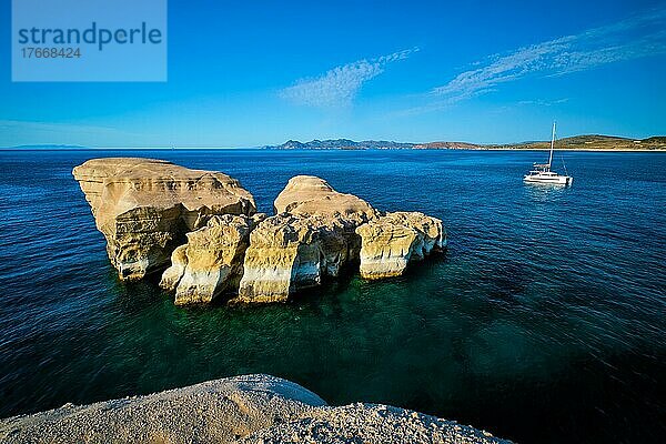 White rocks of famous tourist attraction of Milos island Sarakiniko beach and yacht boat at Sarakiniko Beach  Milos island  Greece