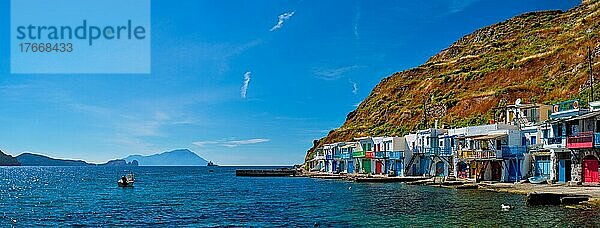 Scenic picturesque greek fishing village Klima with whitewashed traditional houses and colorful windows and doors on Milos island in Greece