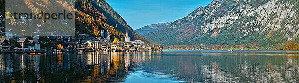 Panorama of Austrian tourist destination Hallstatt village on Hallstatter See in Austrian alps in autumn with traditional autstrian boat  Salzkammergut region  Austria