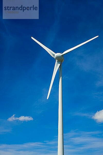 Green renewable alternative energy concept  wind generator turbines generating electricity in blue sky