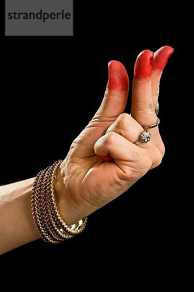 Woman hand showing Kangula hasta (hand gesture) (also called mudra) (meaning Tail) of indian classic dance Bharata Natyam. Also used in other indian classical dances Kuchipudi and Odissi