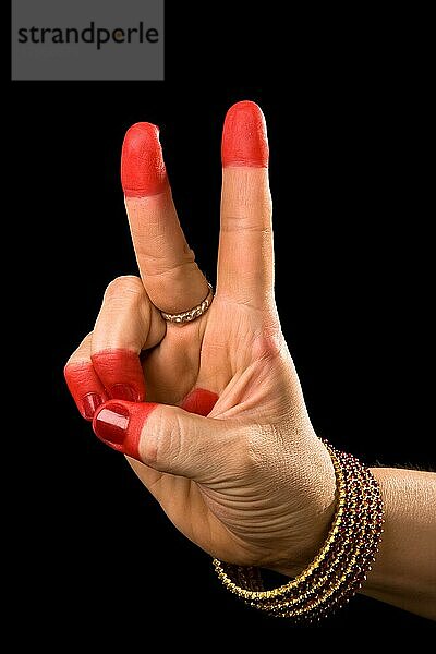 Woman hand showing Kartarimukha hasta (meaning scissors) of indian classic dance Bharata Natyam