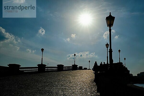 Silhouettes of people and street lamps on the bridge  Antwerp  Belgium