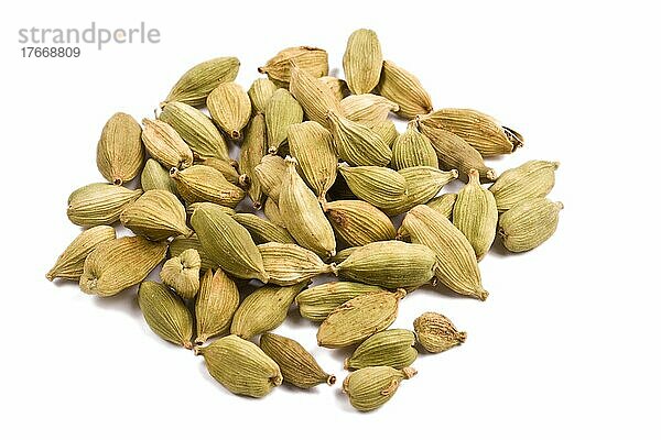 Pile of cardamom before white background close up