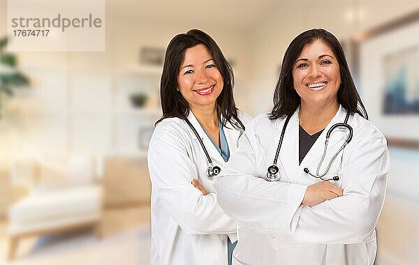 Female hispanic doctors or nurses standing in an office