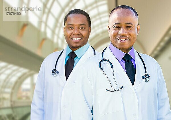 Two handsome african american male doctors inside hospital office