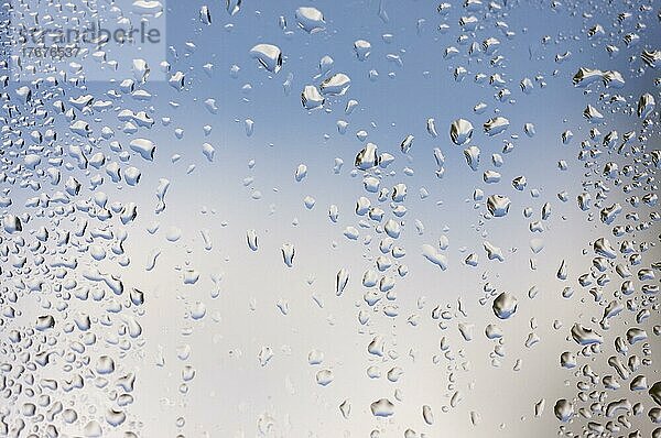 Rain drops on window as the clouds clear behind