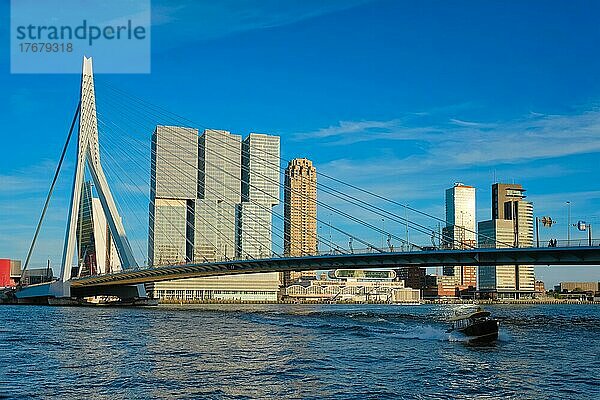 Erasmusbrücke über die Nieuwe Maas bei Sonnenuntergang mit einem Schnellboot  das unter der Brücke durchfährt. Rotterdam  Niederlande  Europa