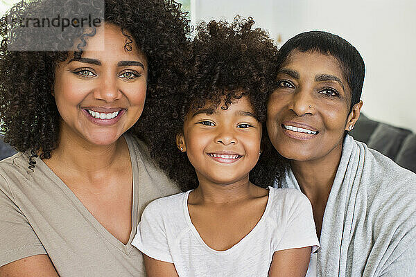 Happy multi-generation family sitting in living room