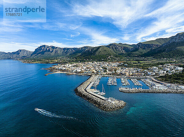 Spain  Balearic Islands  Colonia de Sant Pere  Helicopter view of coastal town in summer with mountains in background
