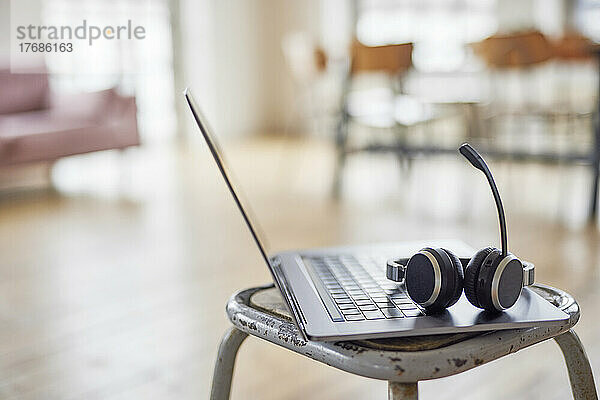Headset on laptop on stool