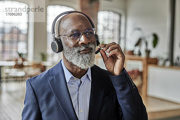 Geschäftsmann hört zu Hause Musik über Headset