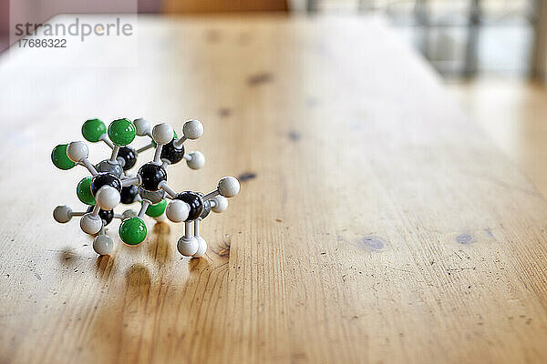 Molecular structure on wooden table