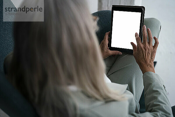 Geschäftsfrau berührt den Bildschirm eines Tablet-PCs