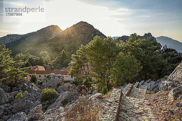 Holy Monastery of Agios Dimitrios amidst mountains at sunset