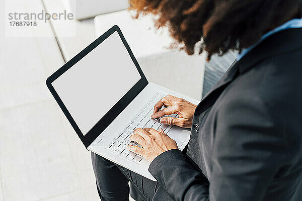 Mature businesswoman typing on laptop