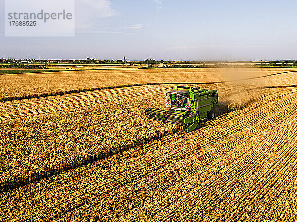 Combine harvester at agricultural field on sunny day