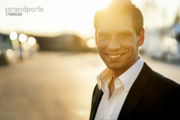 Smiling mature businessman at sunset