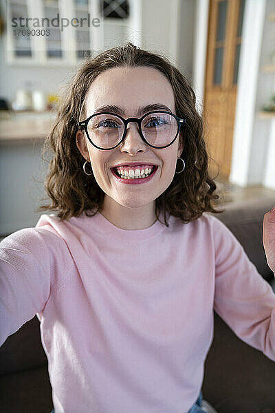 Fröhliche Frau mit Brille zu Hause