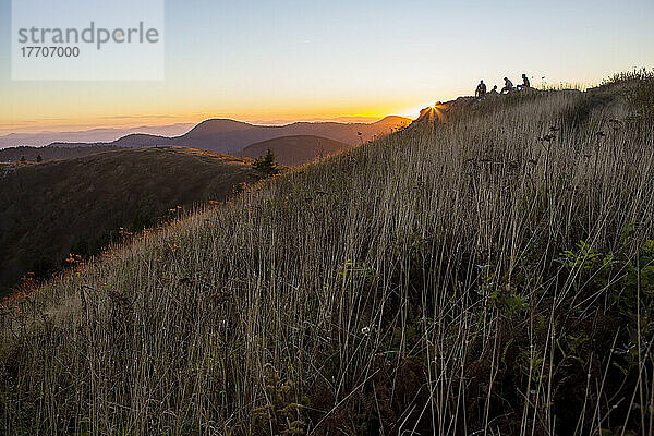 Eine Gruppe junger Männer beobachtet am Black Balsam Knob den Sonnenuntergang über den Blue Ridge Mountains in North Carolina  USA; North Carolina  Vereinigte Staaten von Amerika