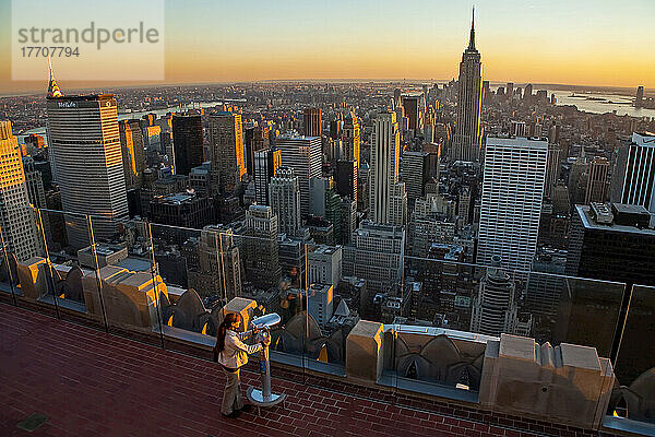 Tourist in der Dämmerung mit Blick auf New York City von einer Aussichtsplattform aus.