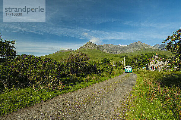 Old 1960's Vw Van Coming Down The Road With The Hills Of The Black Cuillin Behind; Glen Brittle  Isle Of Skye  Schottland