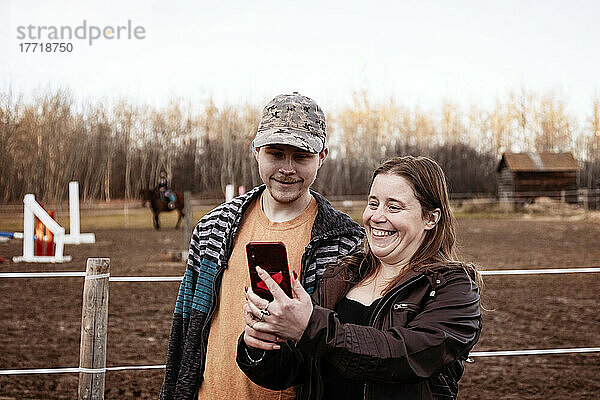 Eine Mutter mit Epilepsie macht ein Selbstporträt mit ihrem Sohn  der das Aspberger-Syndrom hat  in einem Pferdezentrum; Westlock  Alberta  Kanada