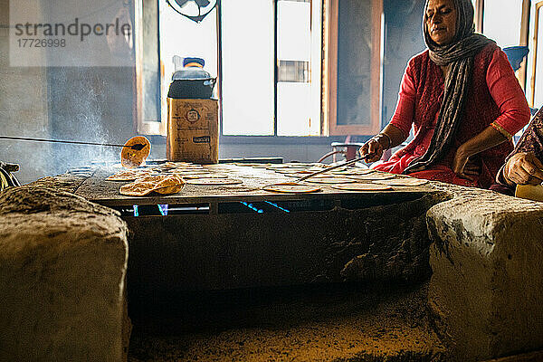 Fresh Roti being handmade on a flatop grill inside the Golden Temple  Amritsar  Punjab  India  Asia