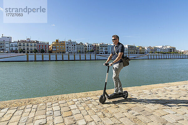 Riding an e-scooter in Seville  Andalusia  Spain  Europe