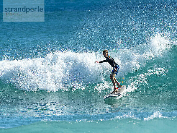 Surfer riding a wave at Ningaloo Reef  Western Australia  Australia  Pacific