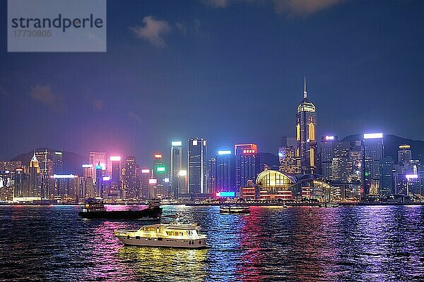 Hongkong Skyline Stadtbild Wolkenkratzer in der Innenstadt über Victoria Harbour in den Abend mit Touristen Boot Fähren beleuchtet  Hongkong  China  Asien