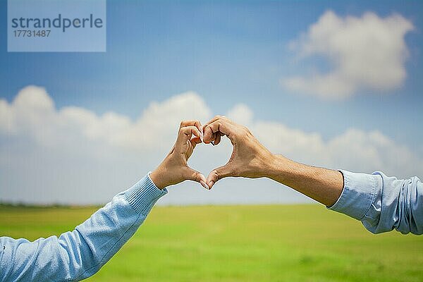 Nahaufnahme der Hände eines Paares  das mit den Händen eine Herzform bildet  Hände eines verliebten Paares auf dem Feld  das eine Herzform bildet  Paar auf dem Feld
