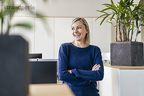 Happy businesswoman laughing in office