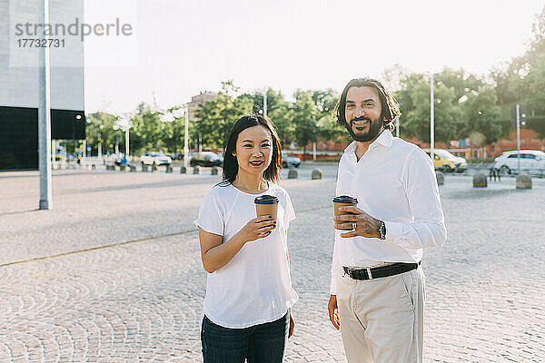 Geschäftskollegen trinken Kaffee auf dem Fußweg in der Stadt